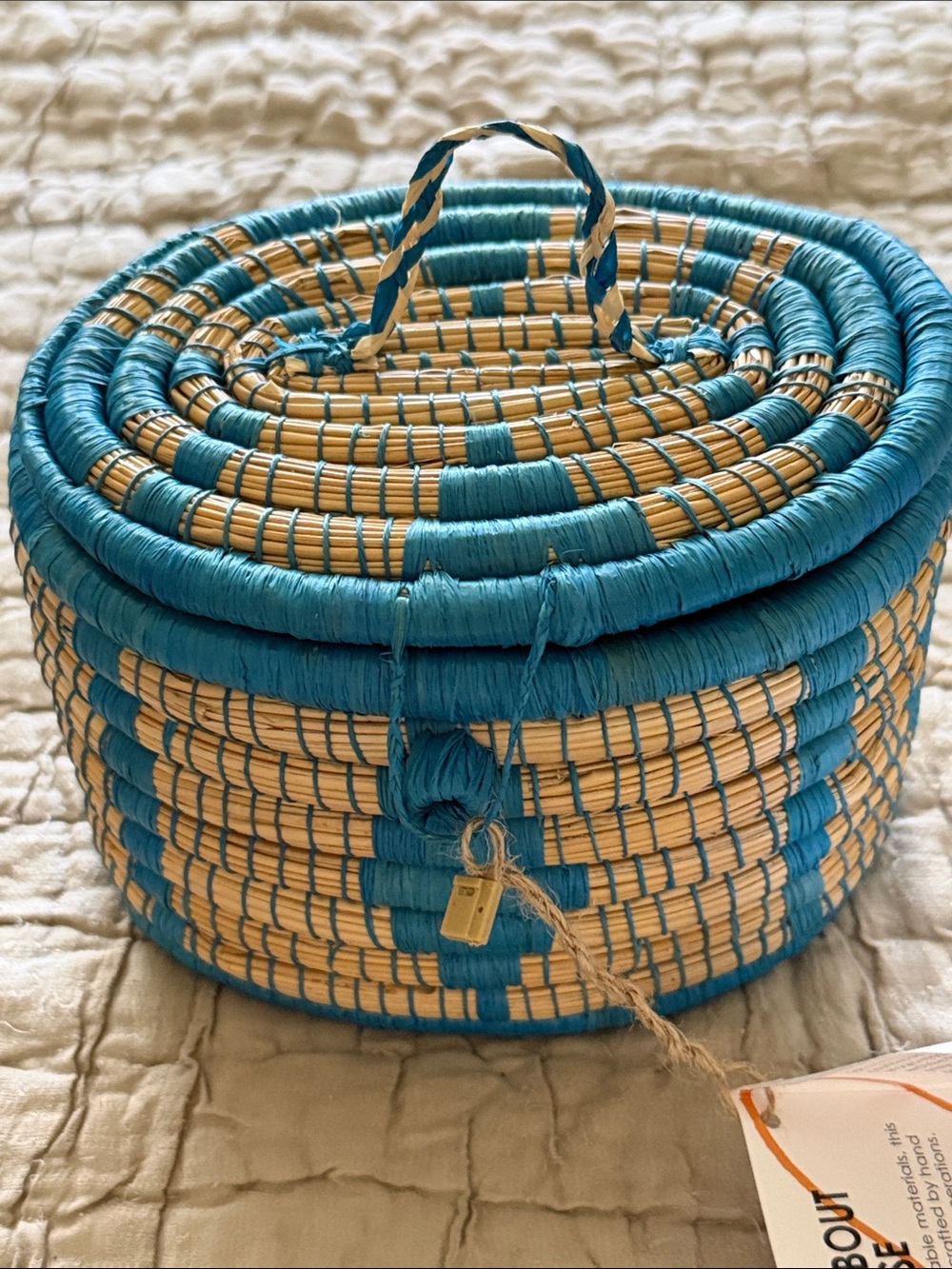 Handmade turquoise and tan coveted basket from Uganda clasp in the front